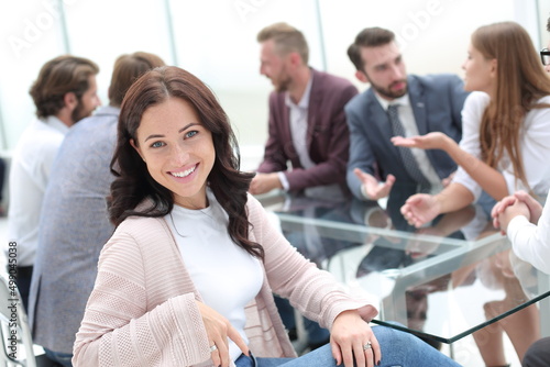 young business woman sitting at corporate business team meeting .