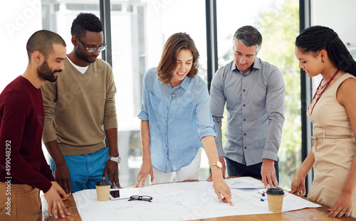 Theyll take care of all your designing needs. Cropped shot of a group of architects in the boardroom. photo