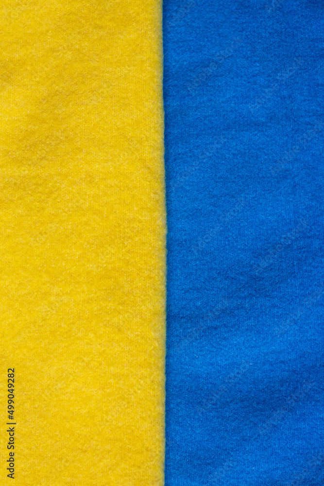Colors of the Ukrainian flag. Soft knit sweaters in yellow and blue. Support for Ukraine. Background and texture of warm soft cozy knitted sweater Colors of the Ukrainian flag. Soft knit sweaters in yellow and blue. Support for Ukraine. Background and texture of warm soft cozy knitted sweater