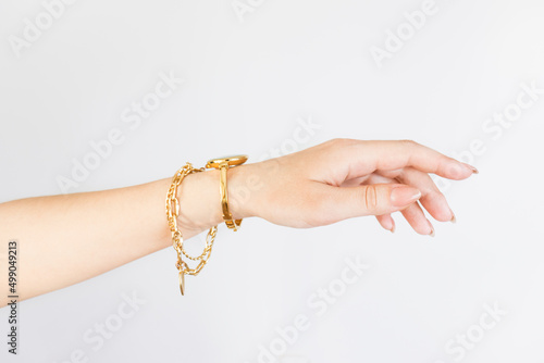 women hand with a chain bracelet and a watch, manicure,
