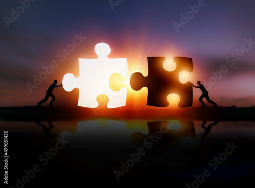 Two businessmen put two puzzles together. Teamwork, cooperation and cooperation concepts