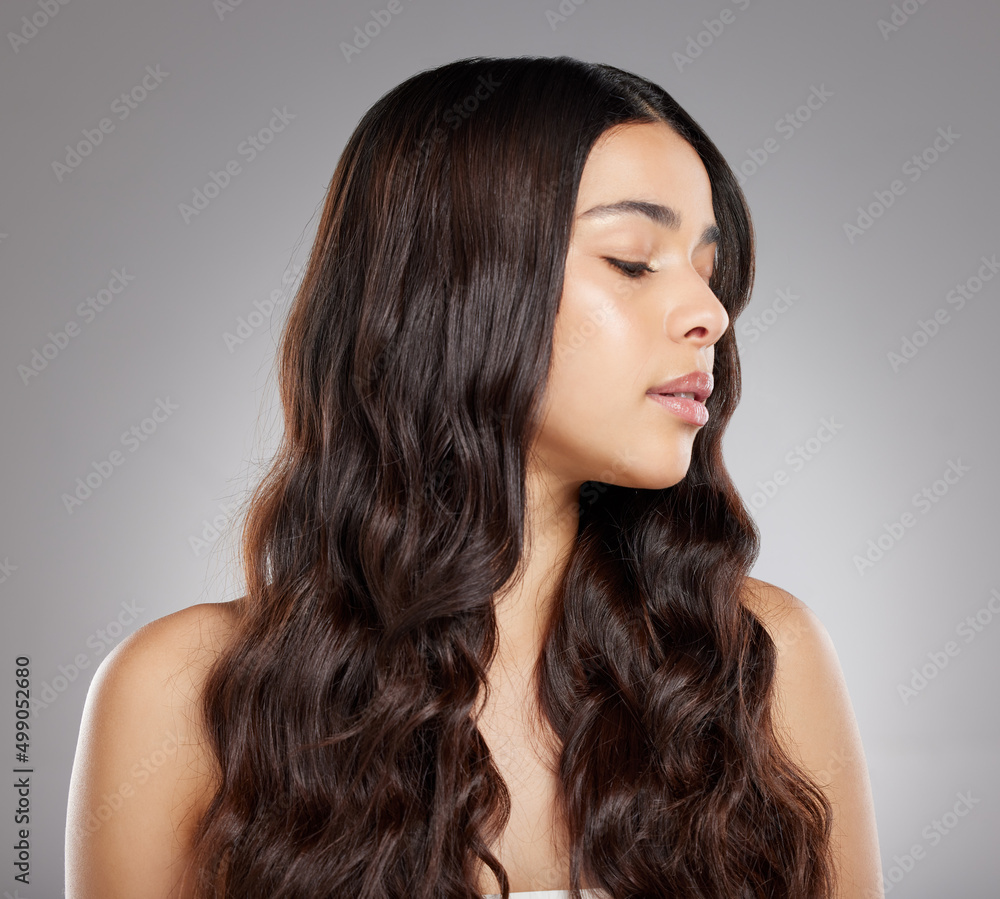 Shes gorgeous. Studio shot of an attractive young woman posing against a grey background. Shes gorgeous. Studio shot of an attractive young woman posing against a grey background.