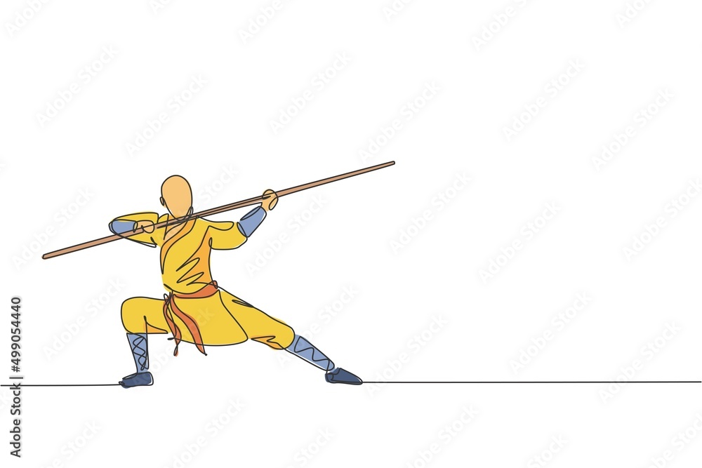 One single line drawing of young energetic shaolin monk man exercise kung fu fighting with stick