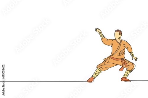 Single continuous line drawing young muscular shaolin monk man train martial art at shaolin temple. Traditional Chinese kung fu fight concept. Trendy one line draw design graphic vector illustration © Simple Line