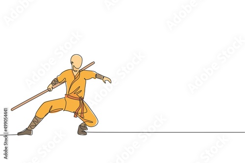 One continuous line drawing of young shaolin monk man practice kung fu with stick at temple ground. Traditional Chinese combative sport concept. Dynamic single line draw design vector illustration