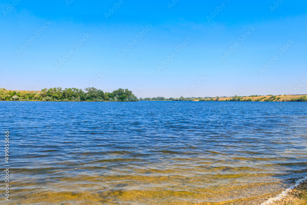 Summer landscape with beautiful river, green trees and blue sky Summer landscape with beautiful river, green trees and blue sky