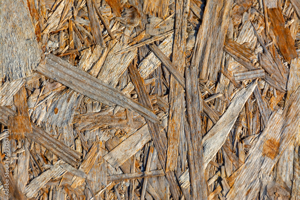 The texture of a wood-fiber board burnt out in the sun. The texture of a wood-fiber board burnt out in the sun.