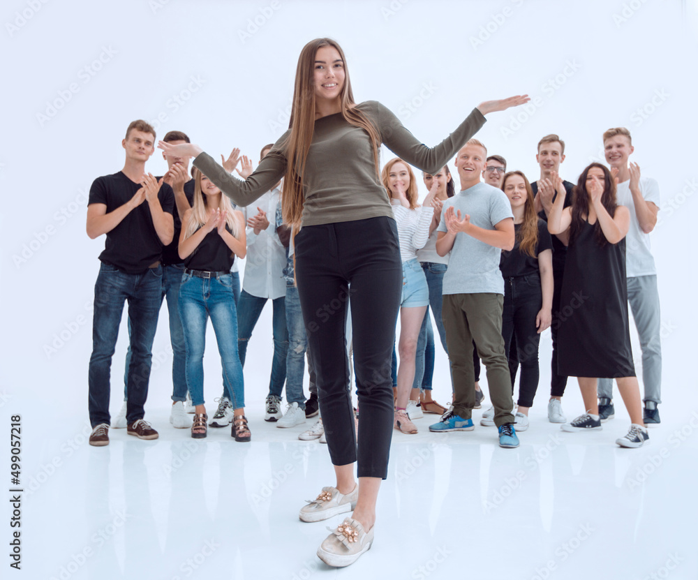 Obraz premium happy friendly girl standing in front of a group of her friends.