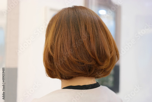 Back view of woman with brown hair in beauty salon