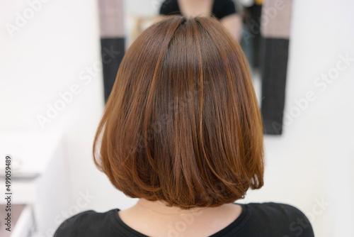Back view of woman with brown hair in beauty salon