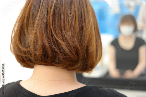 Back view of woman with brown hair in beauty salon