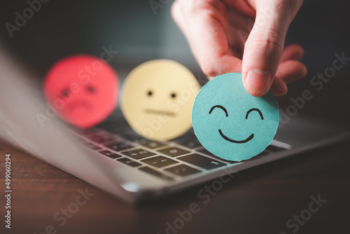 Mental good health Psychology positive emotion human, good feedback rating ,positive customer review, .Hand choosing happy smile cut out paper. photo