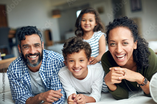 Quality time strengthens their family bond. Portrait of a happy family bonding together at home.