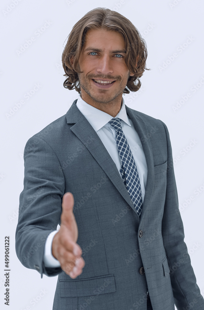 Smiling friendly businessman offers a handshake
