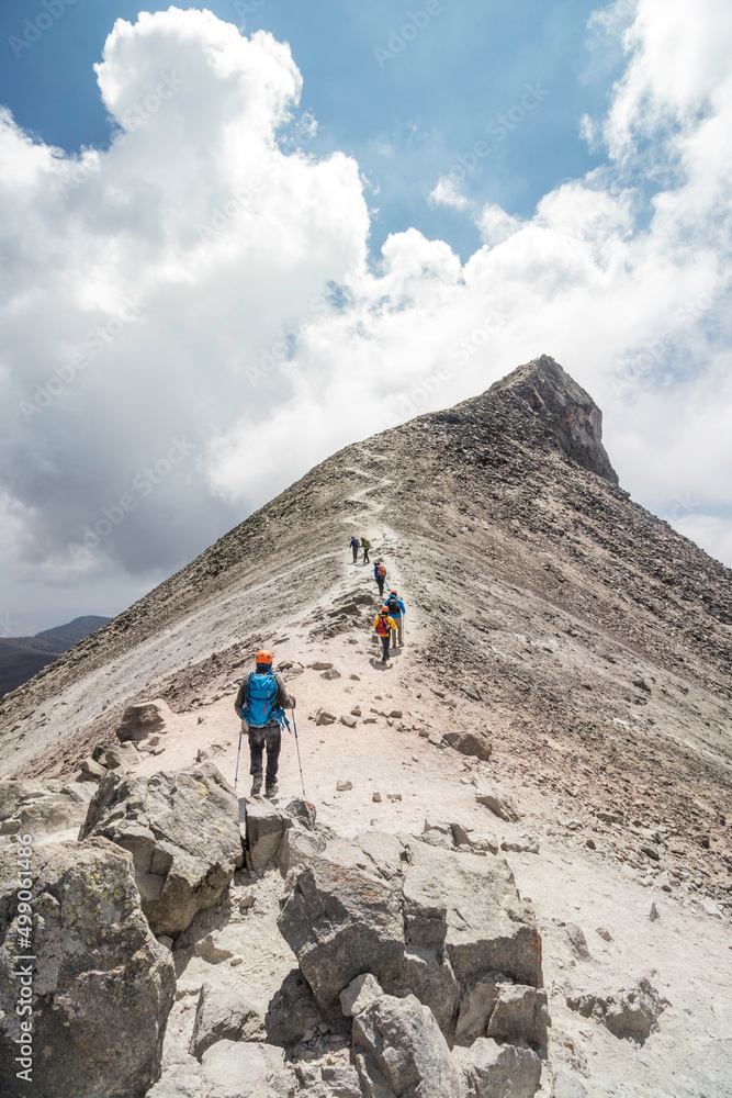 group of hikers walking towards the rocky summit of Nevado de Toluca in Mexico group of hikers walking towards the rocky summit of Nevado de Toluca in Mexico