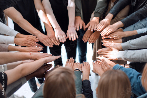 background image of a group of people joining their hands in a circle