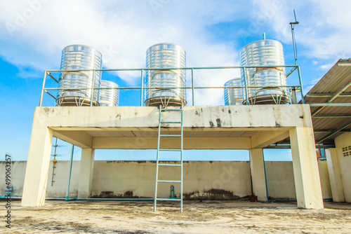 The water storage tank is located on the building.