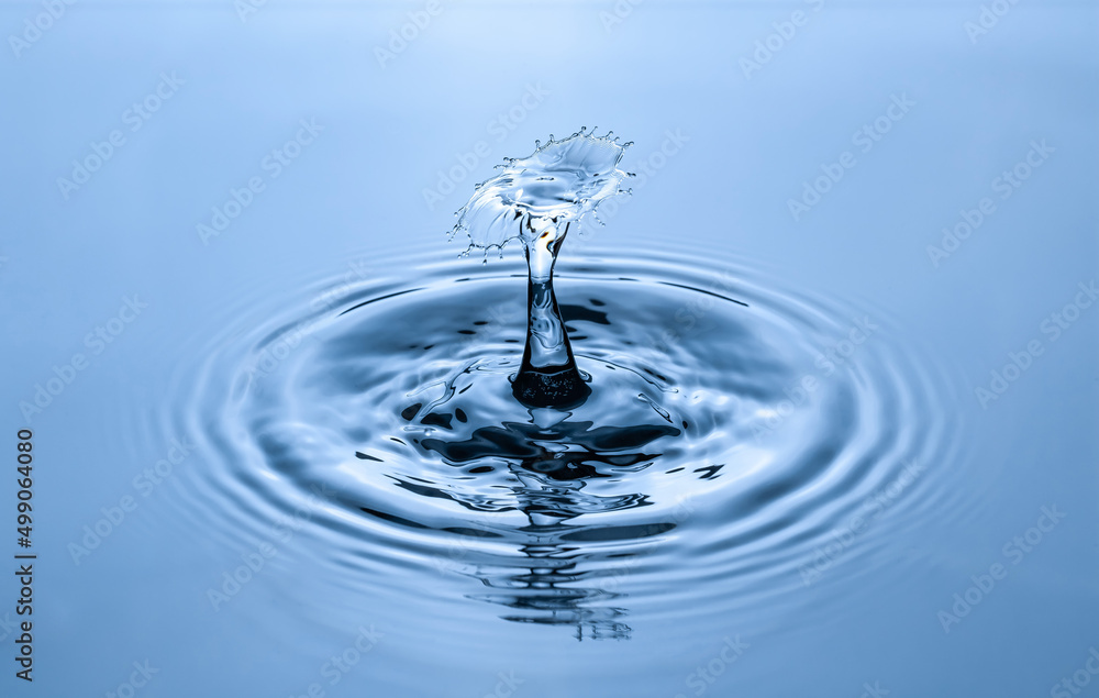 Splash and umbrella on blue background. Reflection on the surface of the water. Splash and umbrella on blue background. Reflection on the surface of the water.