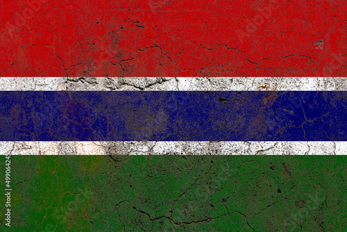 Gambia flag on a damaged old concrete wall surface