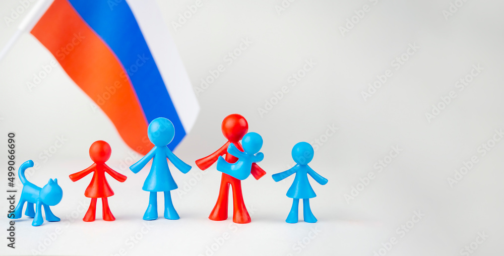 Figures of colored men on a gray background with the flag of Russia in the background. The concept of family, traditions Figures of colored men on a gray background with the flag of Russia in the background. The concept of family, traditions
