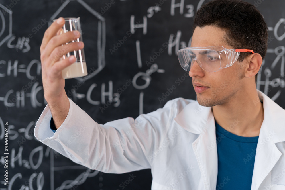 arabic chemist conducting experiment mixing liquids in flask