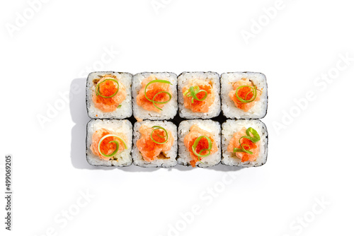 Japanese cuisine - sushi roll with cheese inside,salmon and tobiko caviar outside isolation on white background. Maki sushi with salmon in minimalistic style. Minimal composition with maki sushi.