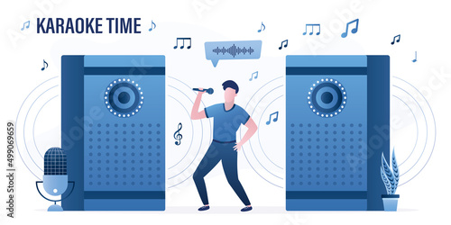 Karaoke time. Funny man sings songs holding a microphone in hand. Large music speakers play music loudly. Home party, weekend or holiday entertainment.