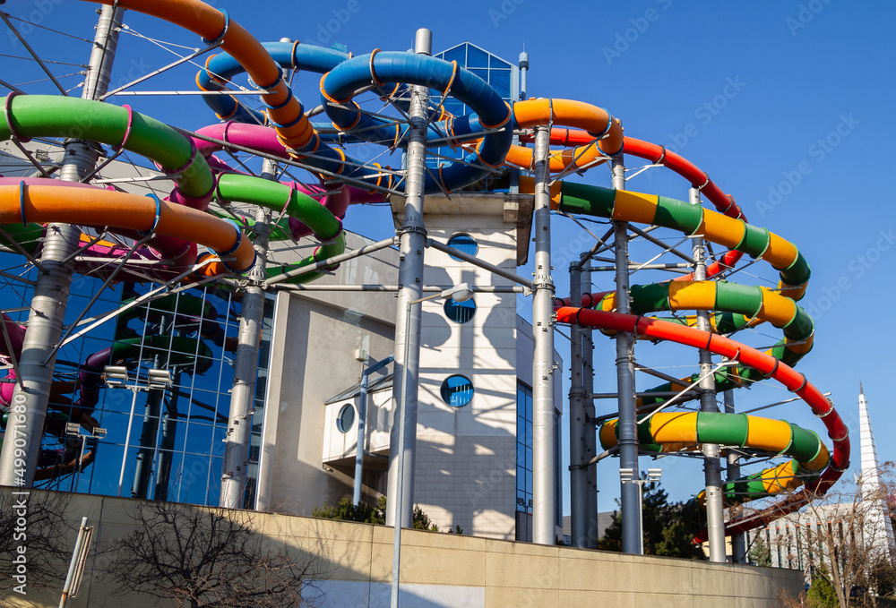 Water slides tubes at Aqua Park in Kraków (Park Wodny w Krakowie) swimming  hall with pools and sauna area on March 21, 2022 in Krakow, Poland. Photos  | Adobe Stock