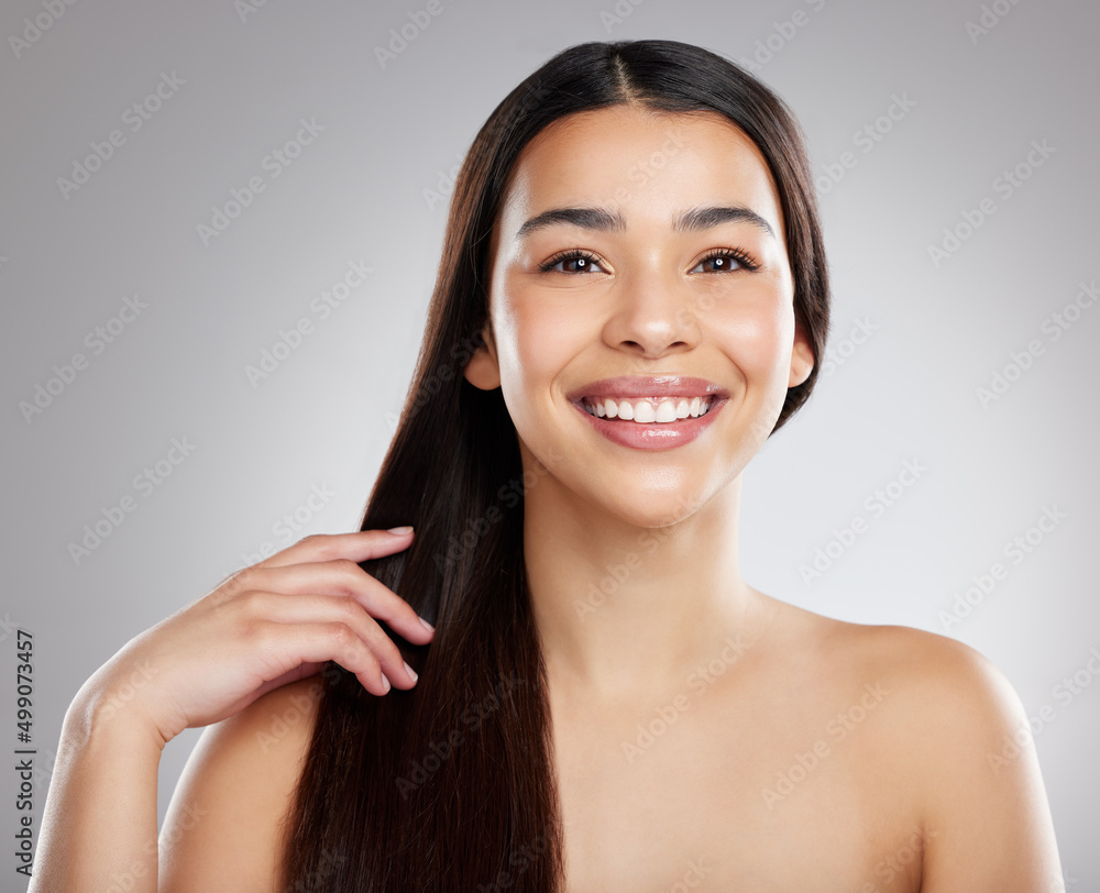 Happiness is a brand new haircut. Studio portrait of an attractive young woman posing against a grey background. Happiness is a brand new haircut. Studio portrait of an attractive young woman posing against a grey background.