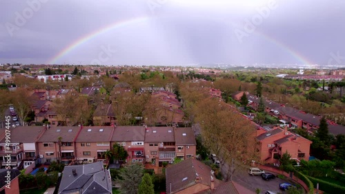 Aerial view Full rainbow in the sky over residential neighborhood. Madrid, Spain photo