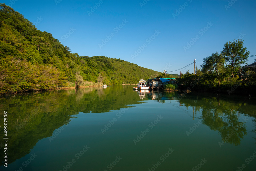 Boat ride on the calm river. It is a popular place and holiday destination on the Göksu river. Reflection of trees. Reflections in the water.
Agva, Sile, Istanbul, Turkey.
