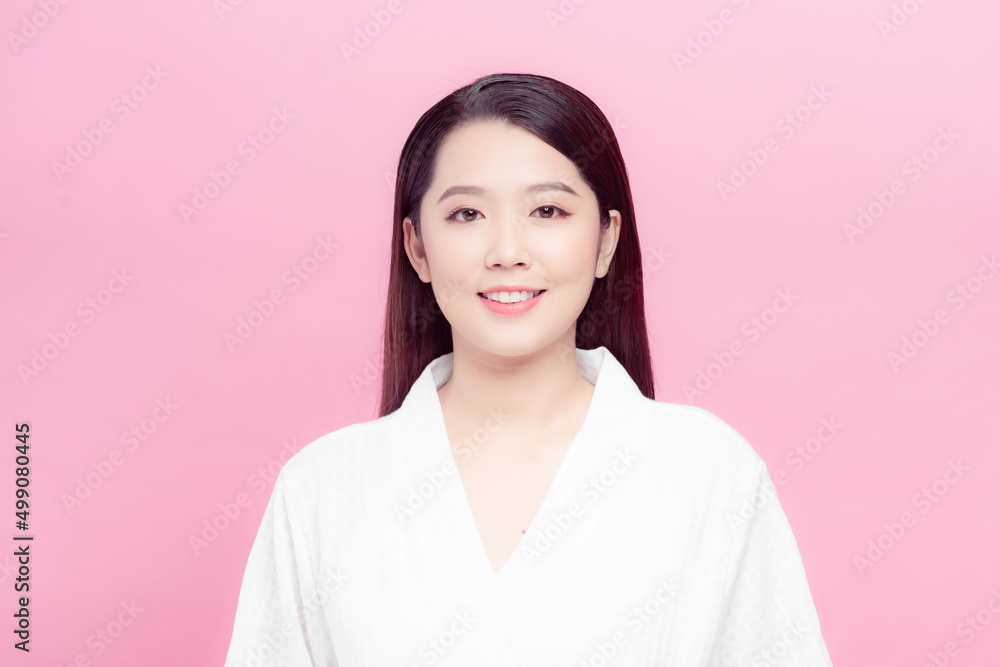 Beautiful young asian woman with clean fresh skin on pink background Beautiful young asian woman with clean fresh skin on pink background