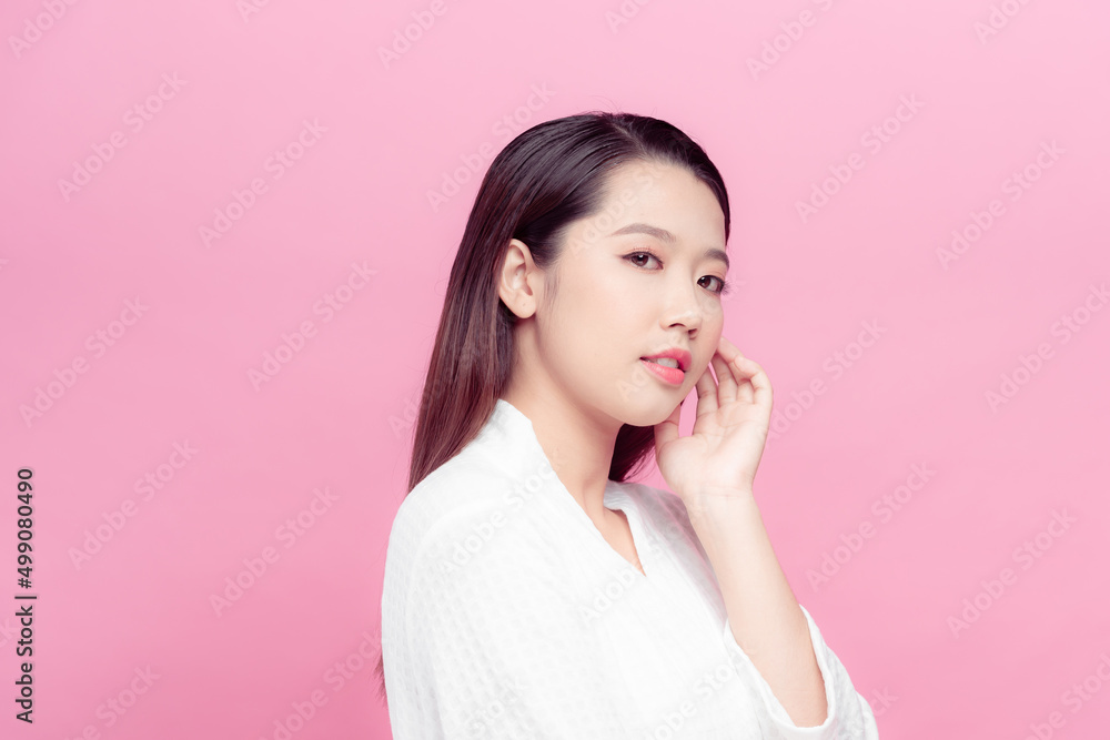 Beautiful young Asian woman touching soft cheek and smile with clean and fresh skin. Beautiful young Asian woman touching soft cheek and smile with clean and fresh skin.