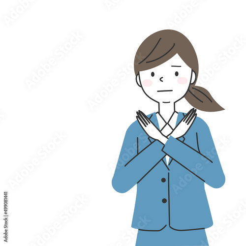 両手で×マークを作るスーツを着た女性