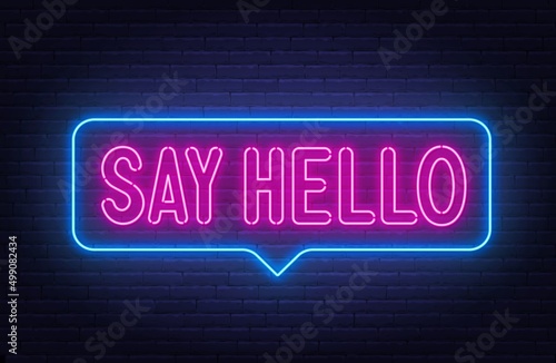 Say hello neon sign in the speech bubble on brick wall background.
