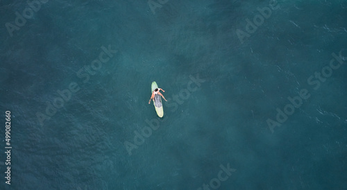 Aerial view of the ocean and surfer girl. © Dima Anikin