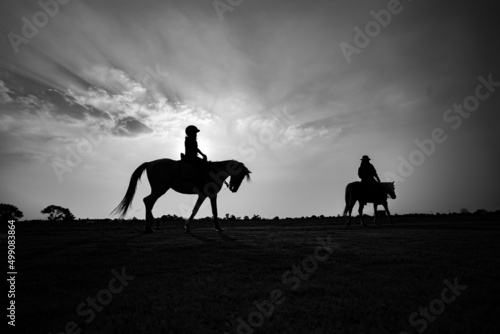 Silhouette of child riding horse in the farm © khamkula