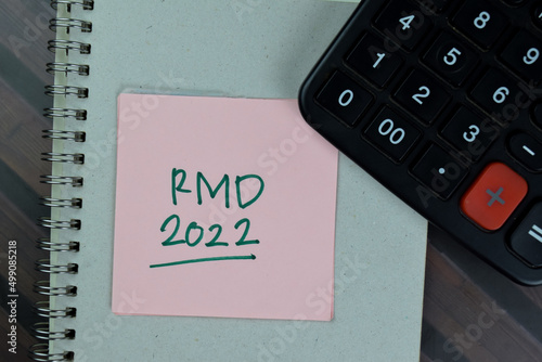 RMD - Required Minimum Distribution 2022 write on sticky notes isolated on Wooden Table. photo