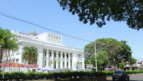 Municipal Town Hall of Bauru build, outside view with local traffic, nice blue sky and trees photo