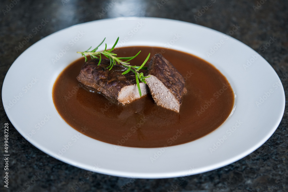 ready to eat, grilled game meat from the roe deer with brown sauce and rosemary ready to eat, grilled game meat from the roe deer with brown sauce and rosemary