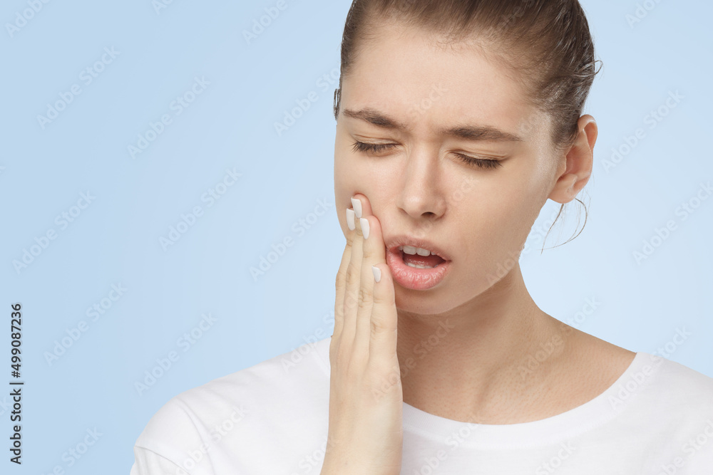Young European woman suffers from severe toothache, feeling strong pain Young European woman suffers from severe toothache, feeling strong pain