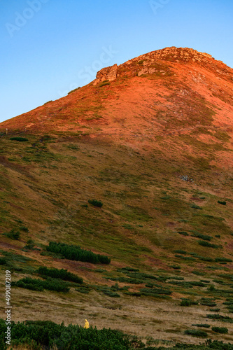 Woman is Mount Turkul, bright clothes in the mountains. photo