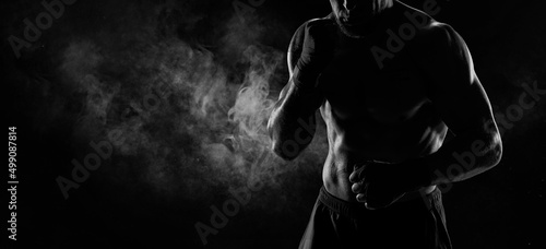 Noname image of a kickboxer on a dark background. The concept of mixed martial arts.