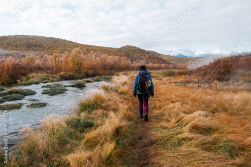 Female walking in mountains, autumn landscape, the first frost on the grass, sunny frosty day, bright colors of nature