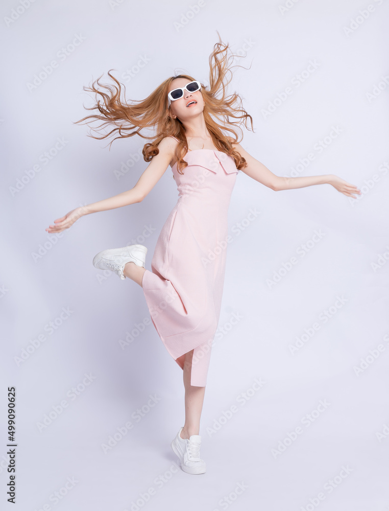 Naklejka premium Full length image of young Asian woman wearing dress on white background
