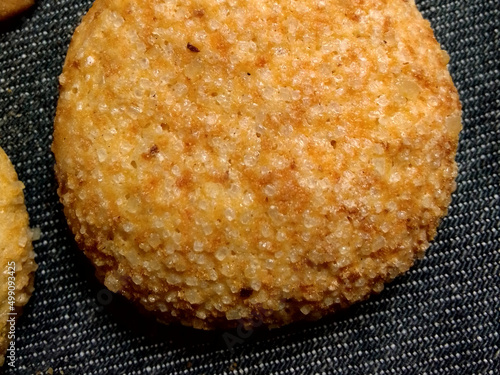 Brown toasted breed in a white sugar isolated in black photo