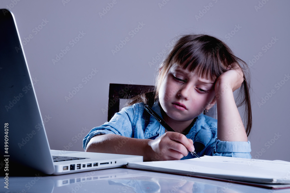 Girl is bored studying online. Negative aspects of distance learning. Girl is bored studying online. Negative aspects of distance learning.