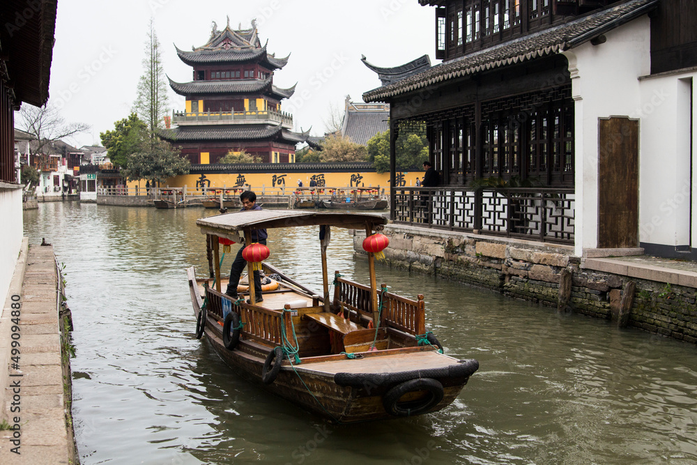 Chinese wooden boat in one of the channels in ancient Zhujiajiao town, China