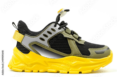 Fotografie Sports sneaker with yellow sole isolated on white background