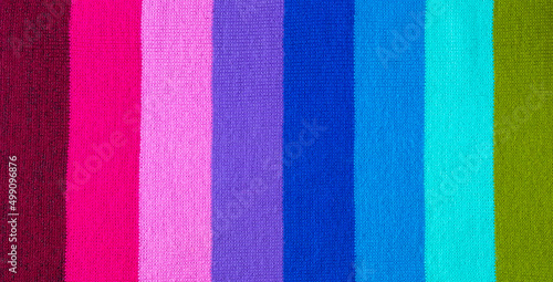 multi colored background. knitted wool fabric texture with stripes